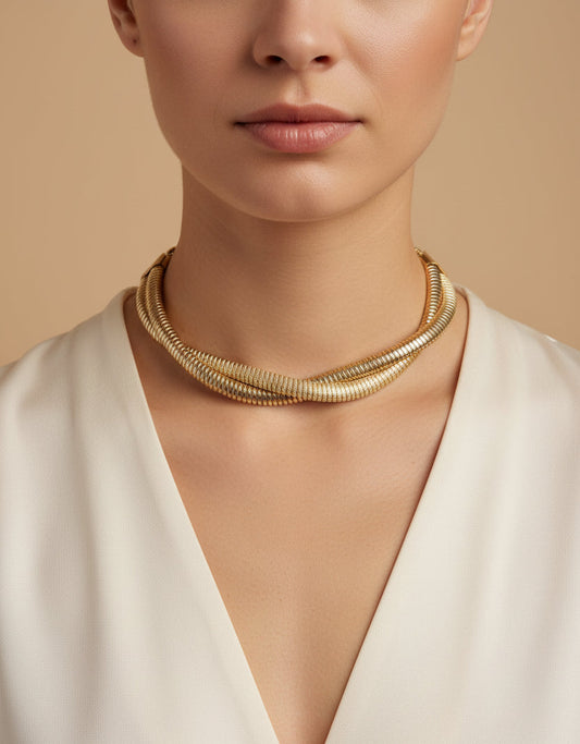 Elegant gold statement necklace featuring intertwined design, perfect for adding sophistication to any outfit.