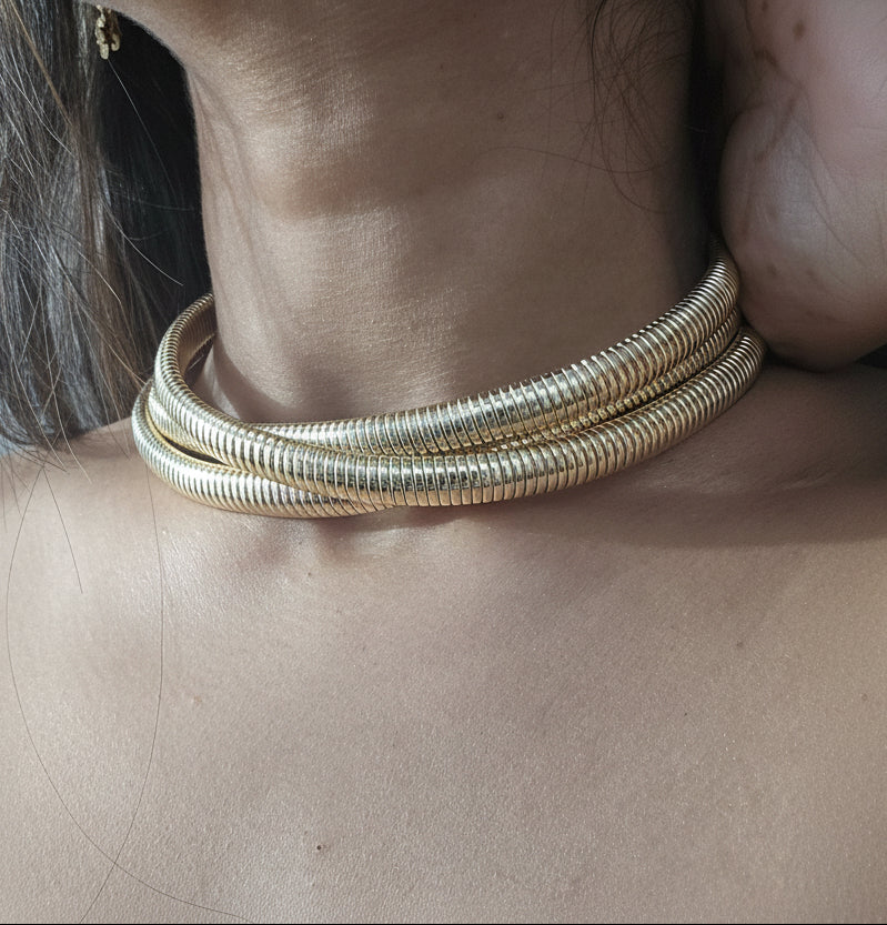 Elegant gold coil choker necklace, multi-layered design, perfect for stylish accessories.
