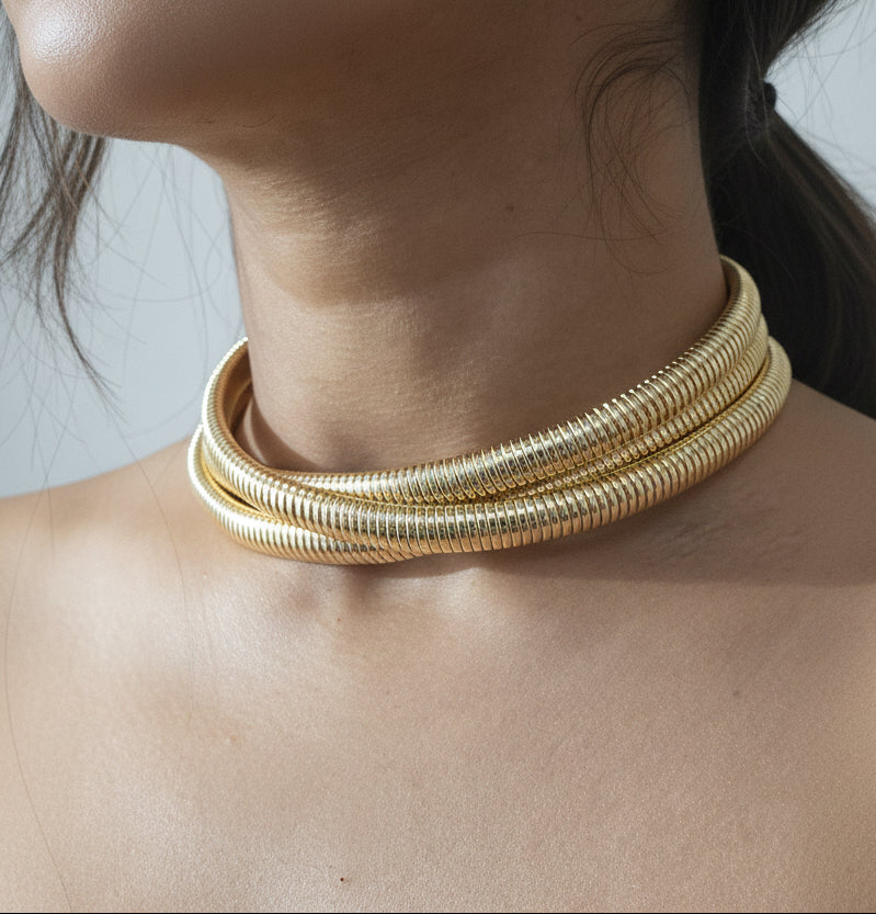 Gold-plated multi-layer choker necklace with a sleek modern design.