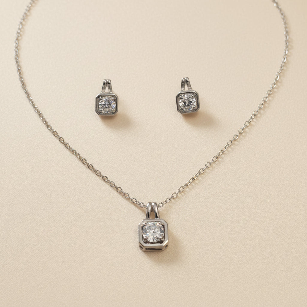 Silver jewelry set with crystal pendant necklace and matching earrings, elegant and stylish.