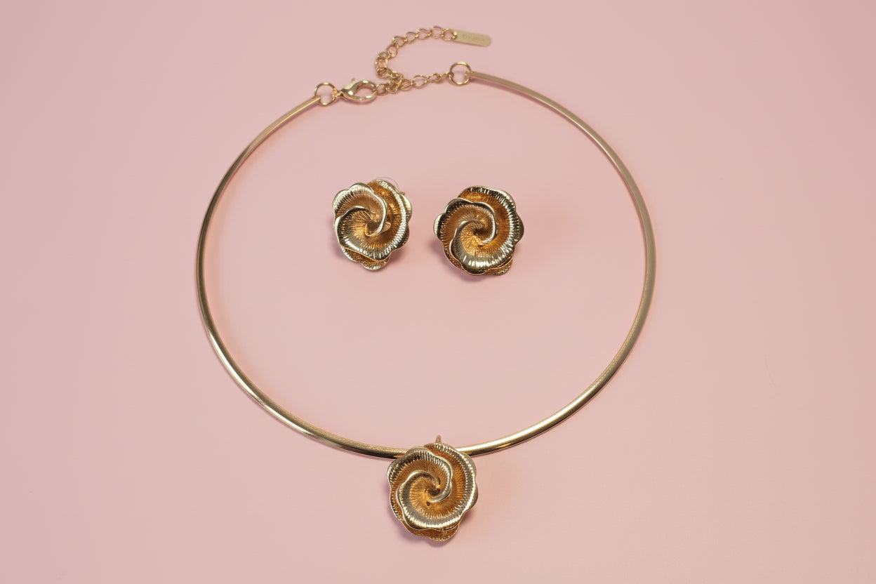 Gold floral necklace and matching earrings set, featuring intricate rose designs for elegant styling.