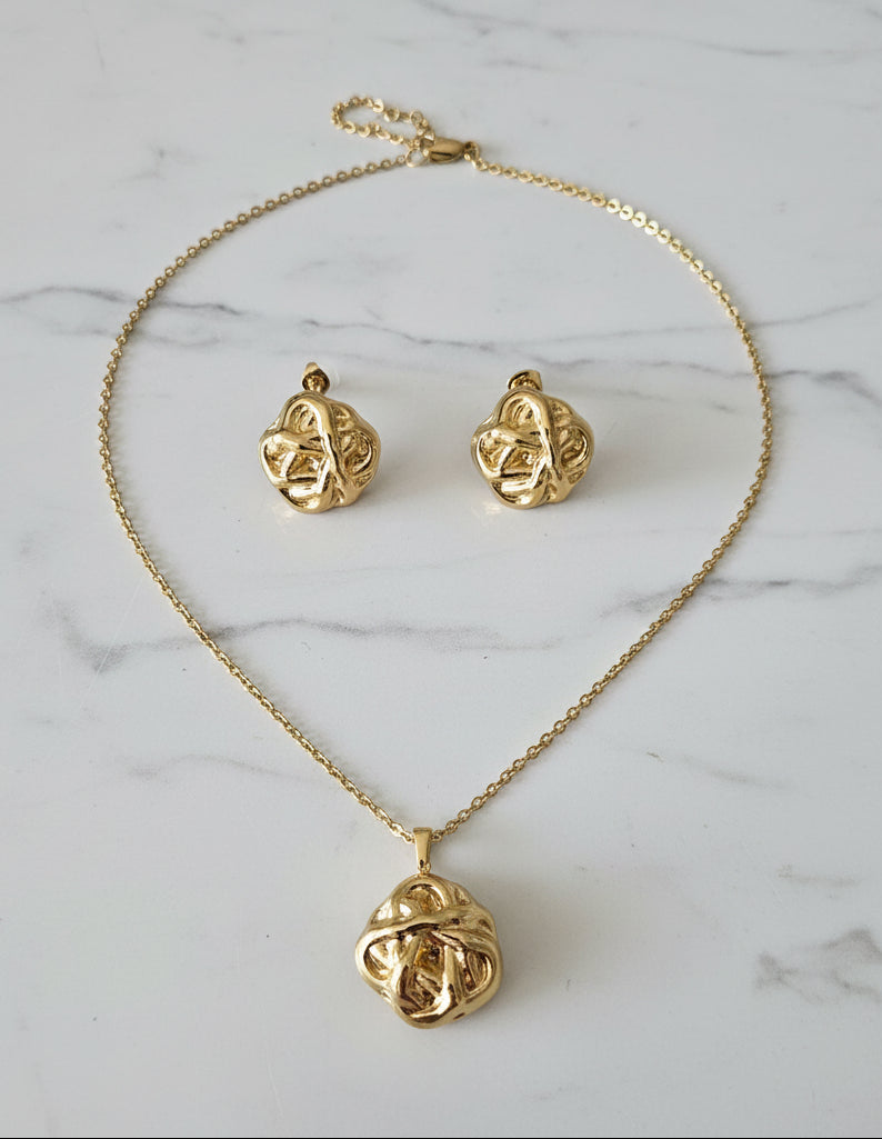 Elegant gold necklace and earrings set featuring intricate knot design, perfect for special occasions.
