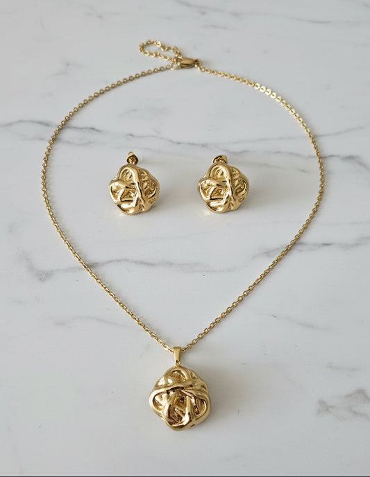 Elegant gold necklace and earrings set featuring intricate knot design, perfect for special occasions.