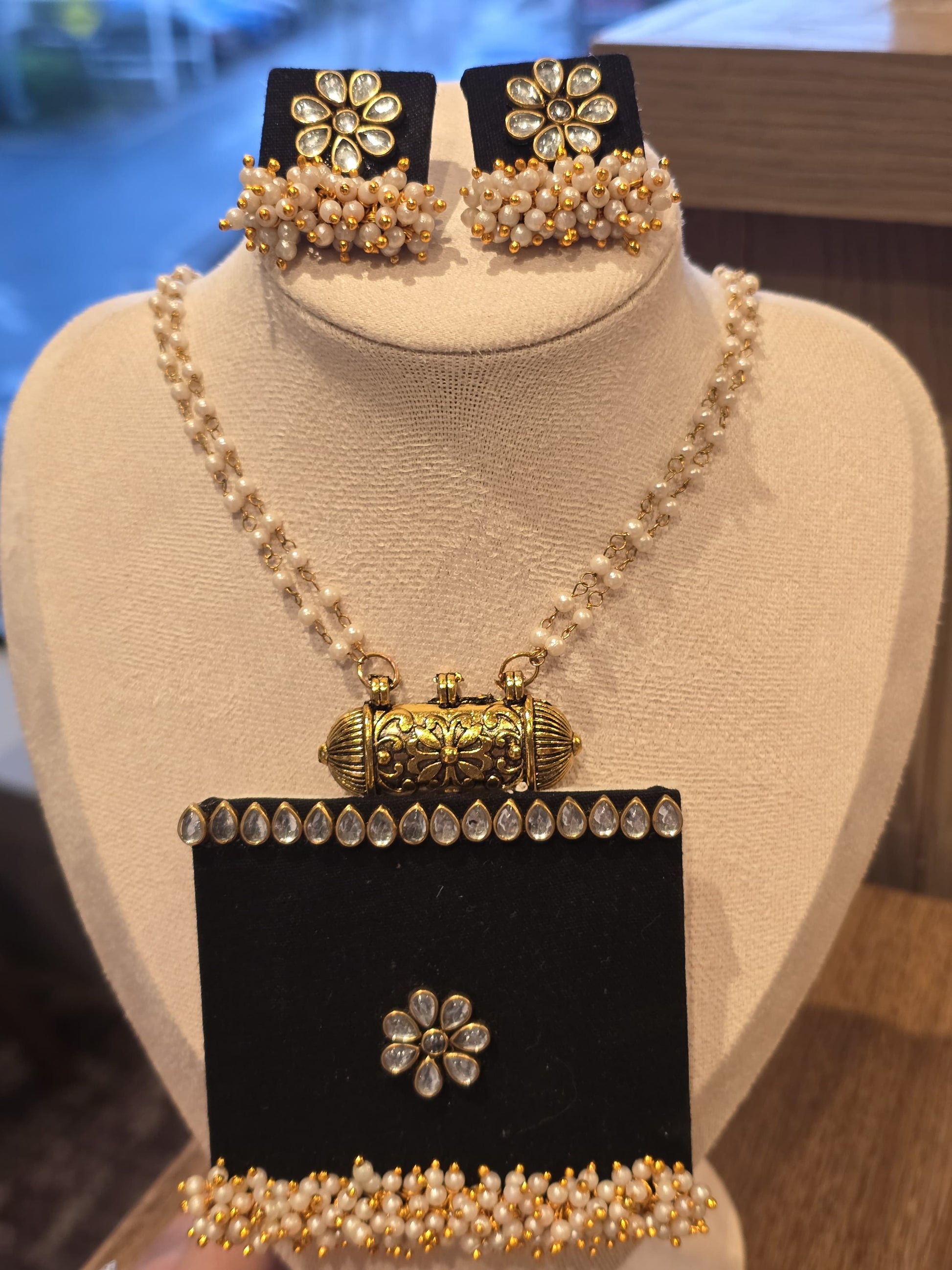 Elegant pearl jewelry set with gold accents, includes necklace and matching earrings, perfect for celebrations.